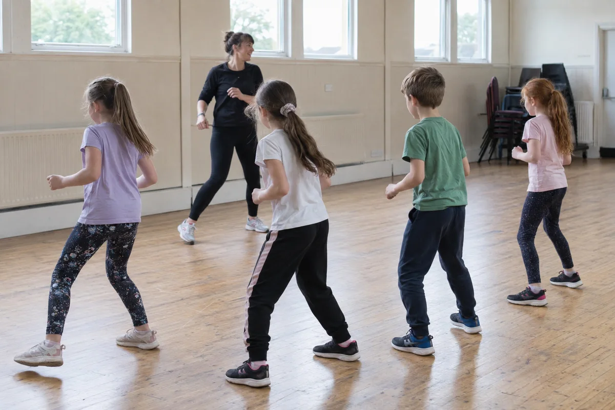 Children following an instructor during a dance class
